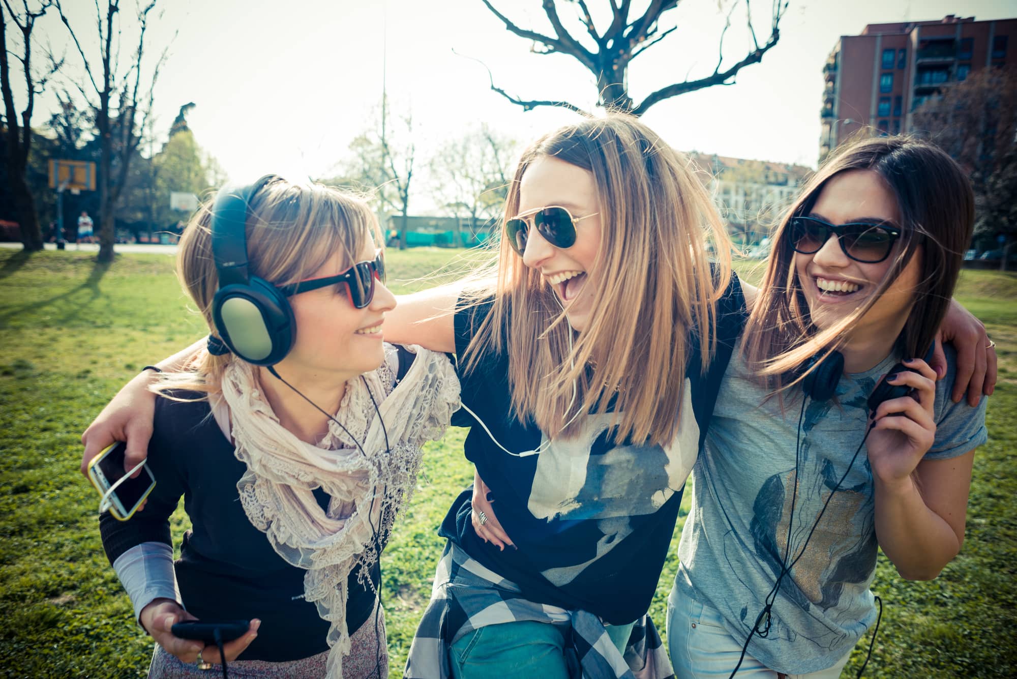 three beautiful friends authentic in urban contest listening to music